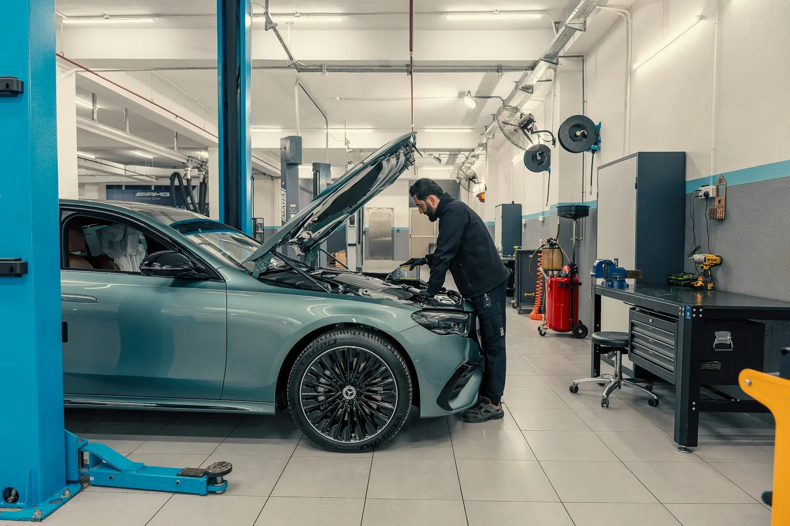 Mechanic working on a vehicle in a workshop. Concept photography; not Amin's premises.